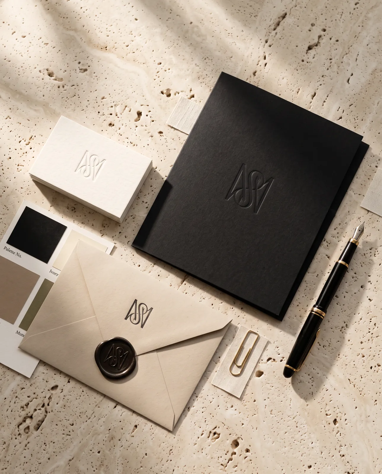 Brand identity flat lay in black, ivory and taupe